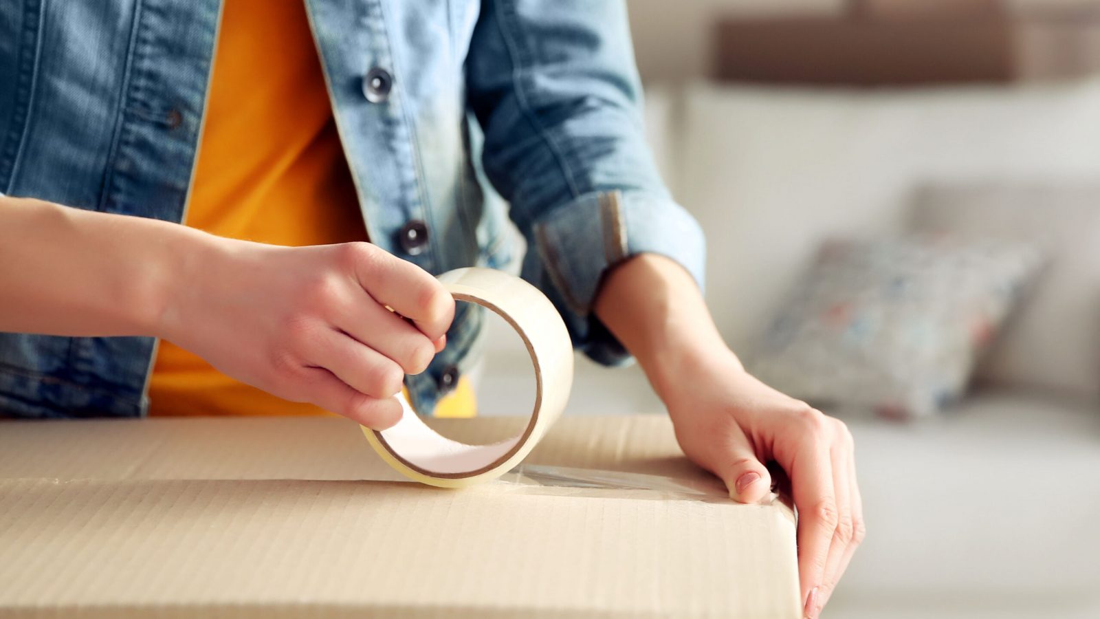 Young,Girl,Sealing,With,Tape,Big,Cardboard,Box,For,Moving